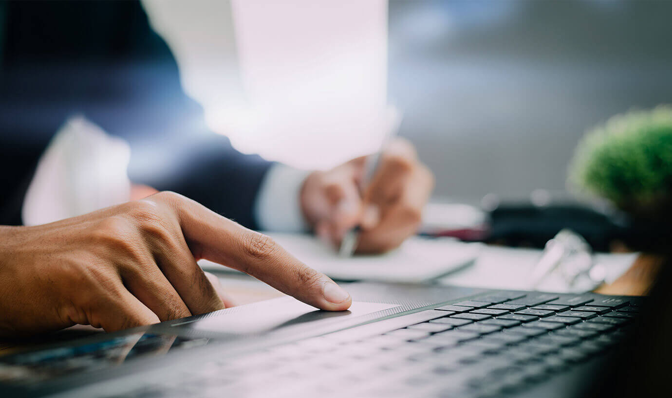 Person on laptop taking notes